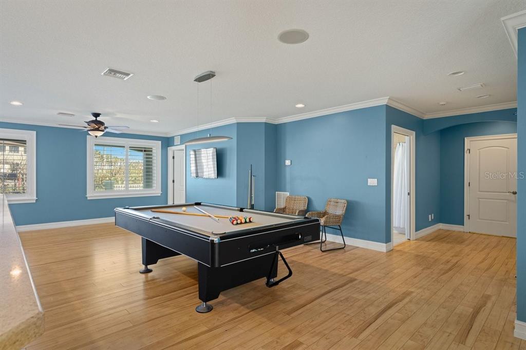 A game room features blue walls, hardwood floors, and a pool table under a pendant light — 2 MAR AZUL N, PONCE INLET, FL