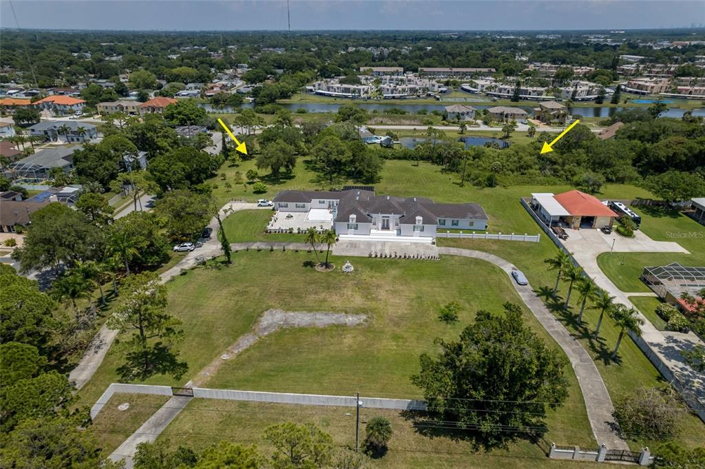 An aerial view shows a large house with a pool and detached garage on acreage — 8181 98TH STREET, SEMINOLE, FL