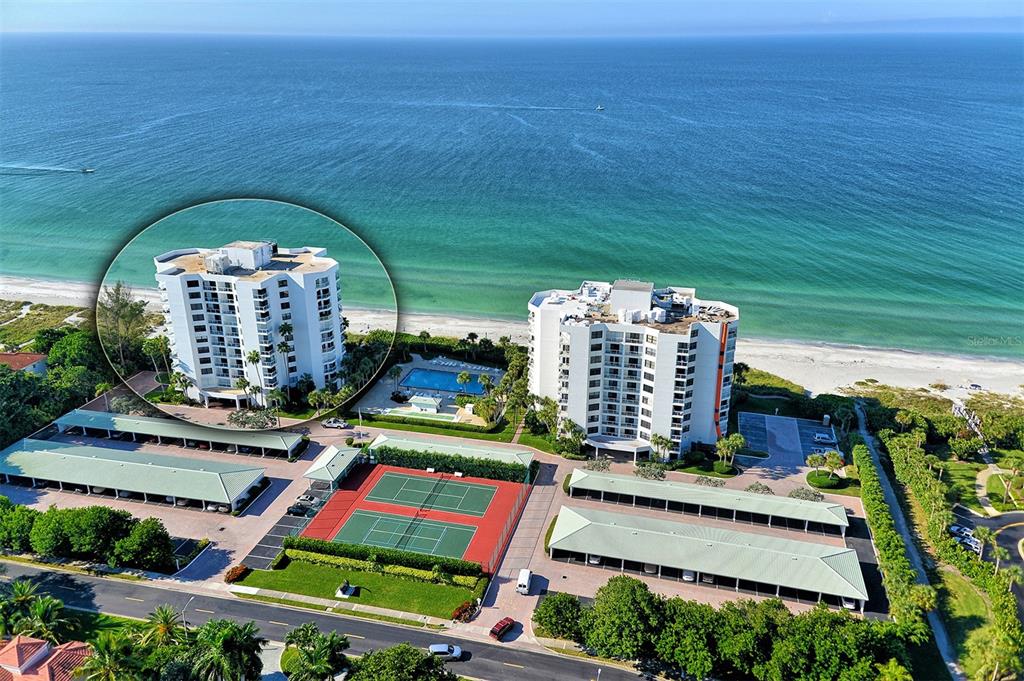 An aerial view shows beachfront condominiums, tennis courts, and a golf course near the ocean — 1000 LONGBOAT CLUB ROAD UNIT 304, LONGBOAT KEY, FL