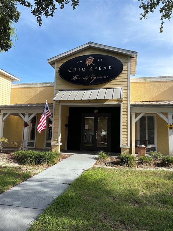 The exterior of a yellow commercial building features a sign for Chic Speak Boutique — 301 W BAY DRIVE UNIT 5, LARGO, FL