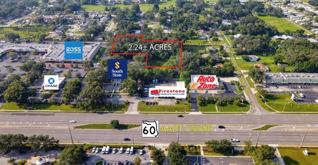 An aerial view shows a 2.24-acre wooded lot located behind commercial businesses along a highway — 205 MORNINGSIDE LOOP, VALRICO, FL