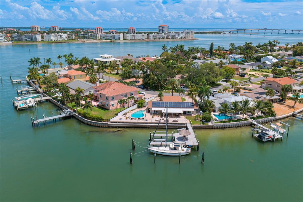 An aerial view of a waterfront home with a private dock, boat, and swimming pool — 3142 W VINA DEL MAR BOULEVARD, ST PETE BEACH, FL
