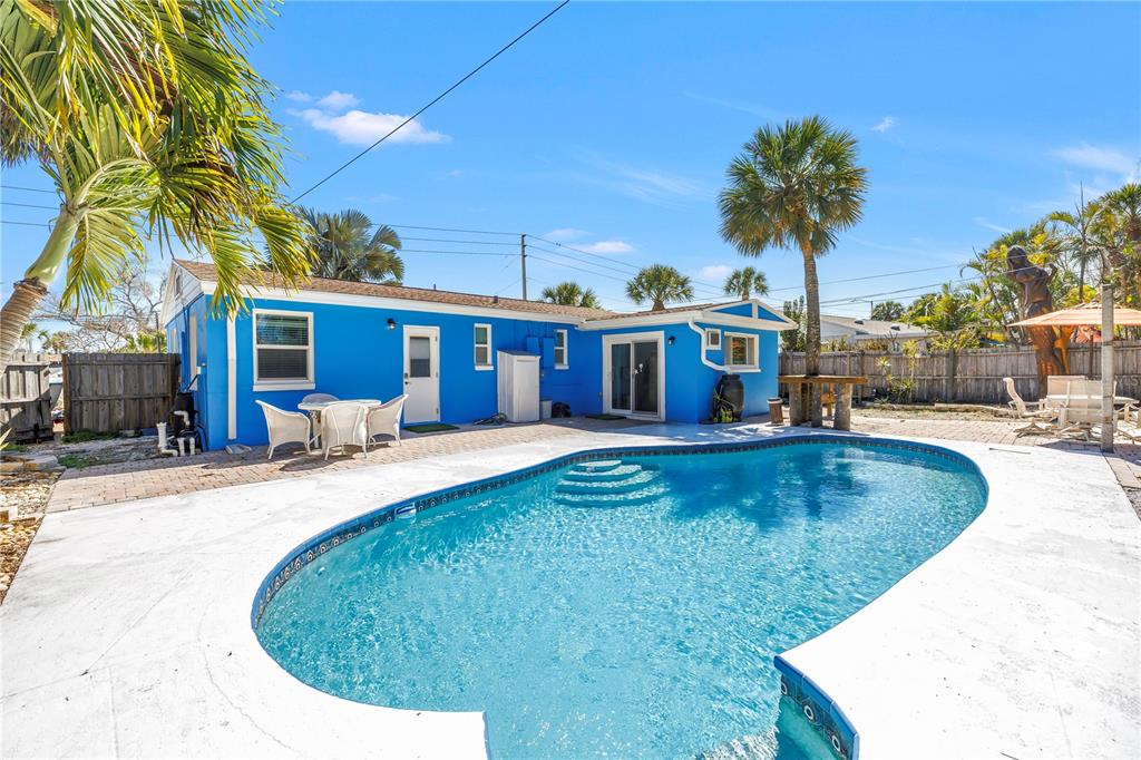 A bright blue house with a swimming pool and patio in the backyard — 6892 GULF WINDS DRIVE UNIT 2, ST PETE BEACH, FL