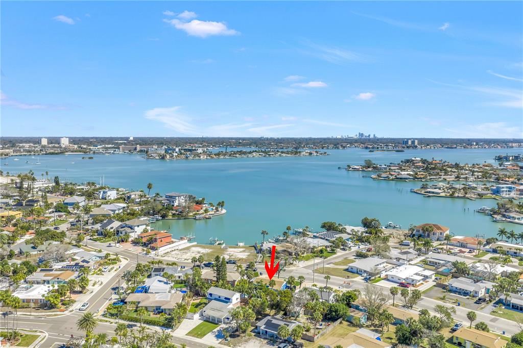 An aerial view shows a coastal residential neighborhood with a red arrow pointing to a house — 6892 GULF WINDS DRIVE UNIT 2, ST PETE BEACH, FL