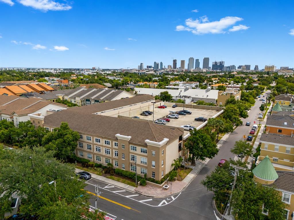 An aerial view shows a multi-story apartment building with an attached parking garage — 520 S ARMENIA AVENUE UNIT 1229E, TAMPA, FL