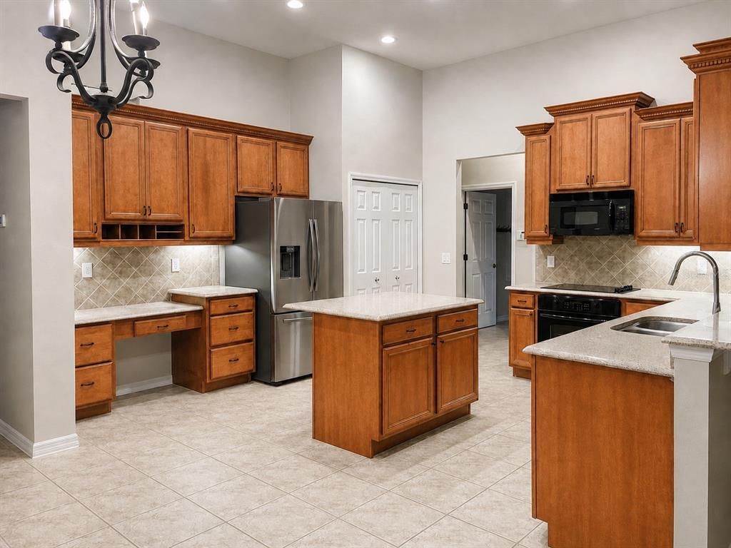 A kitchen with wood cabinets, stainless steel appliances, a center island, and light tile flooring — 105 E BLUE WATER EDGE DRIVE, EUSTIS, FL