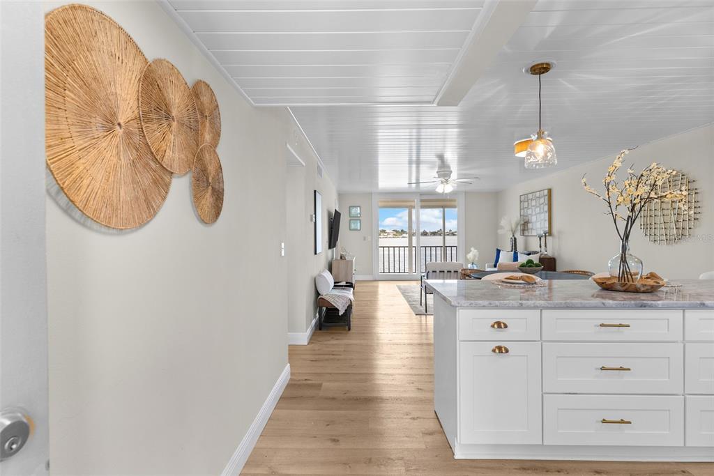 An exterior view of a multi-story waterfront apartment building with a highlighted balcony unit — 7920 SUN ISLAND DRIVE S UNIT 202, SOUTH PASADENA, FL