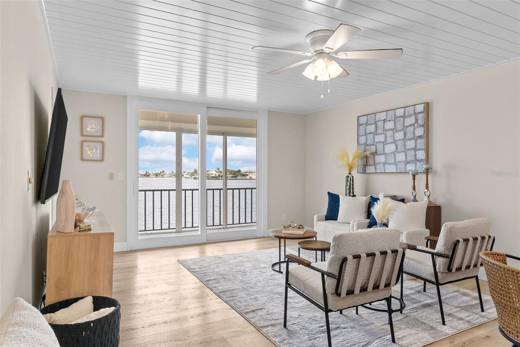An aerial view shows a waterfront residential complex with tennis courts, a marina, and pools — 7920 SUN ISLAND DRIVE S UNIT 202, SOUTH PASADENA, FL