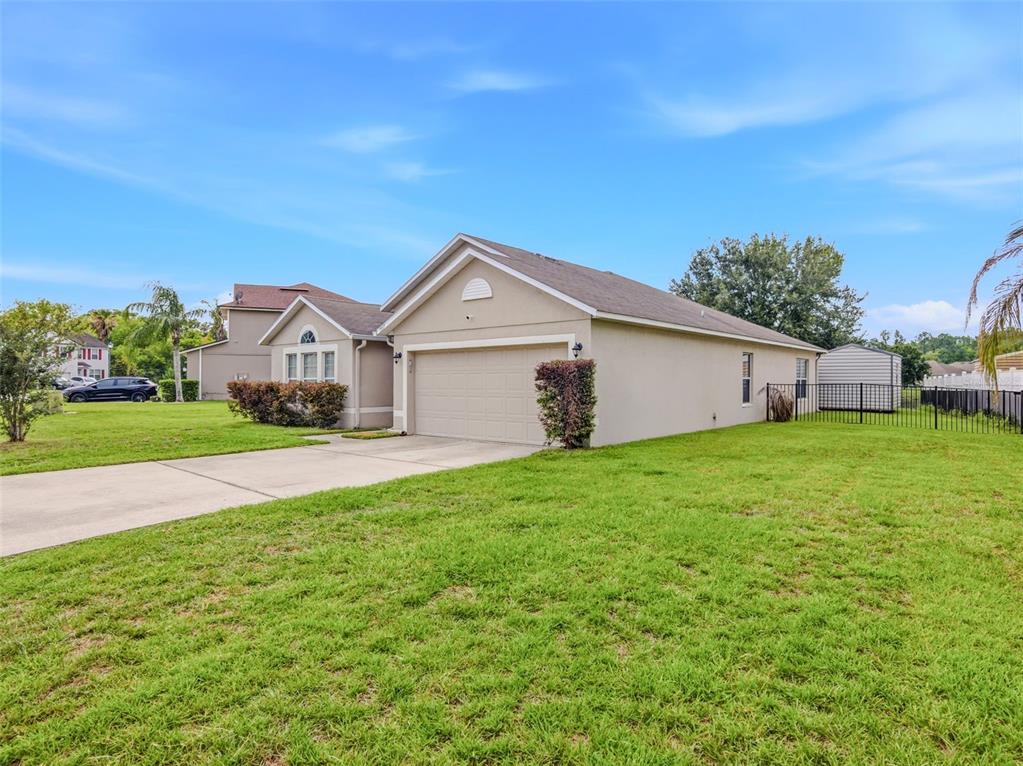 A beige single-story house with a two-car garage and a large grassy front yard — 7357 CUMBRIA BOULEVARD, JACKSONVILLE, FL