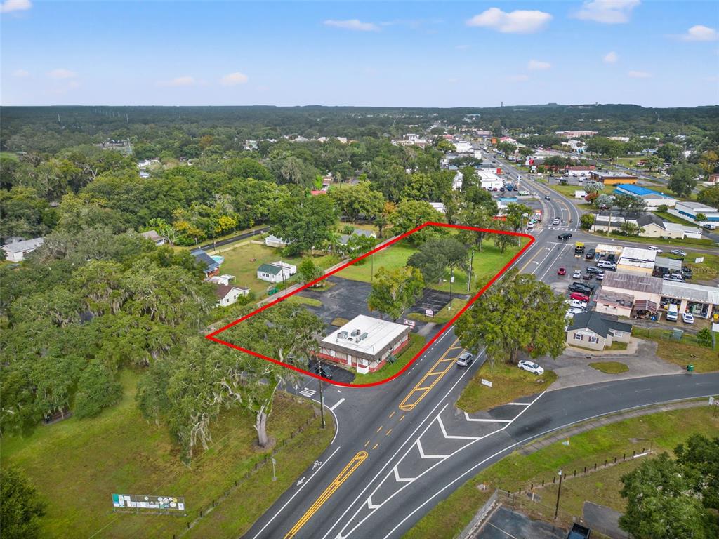 An aerial view shows a commercial building on a lot outlined in red — 4917 GALL BOULEVARD, ZEPHYRHILLS, FL
