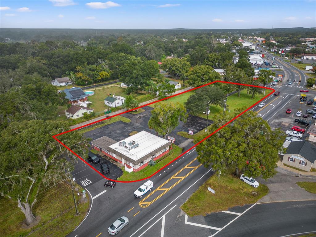 An aerial view shows a commercial building with a parking lot outlined in red — 4917 GALL BOULEVARD, ZEPHYRHILLS, FL