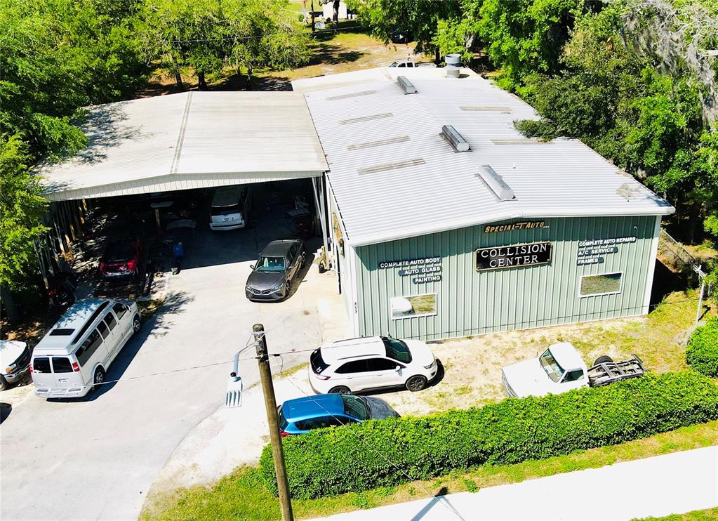 An aerial view of an auto collision center building with several vehicles parked outside — 853 NE 5TH STREET, CRYSTAL RIVER, FL