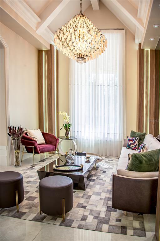 A living room features a large crystal chandelier, a velvet armchair, and a patterned rug — 6719 VALHALLA WAY, WINDERMERE, FL