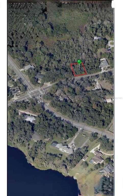 This aerial map shows a rectangular plot of land highlighted in red near a lake — 1778 E NORMANDY BOULEVARD, DELTONA, FL