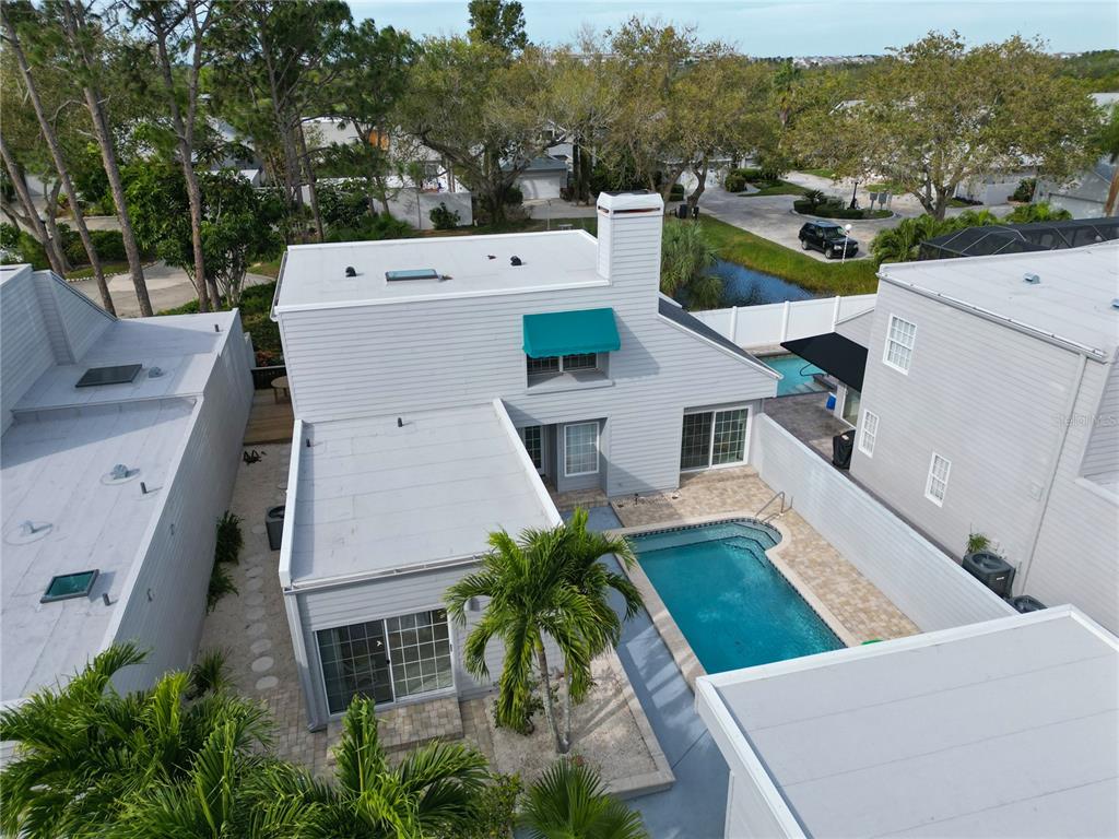 An aerial view shows a two-story house with a private pool and patio area — 11213 VERANDA COURT, BRADENTON, FL