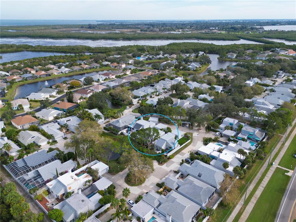 An aerial view shows a suburban neighborhood with a blue circle highlighting a specific house — 11213 VERANDA COURT, BRADENTON, FL