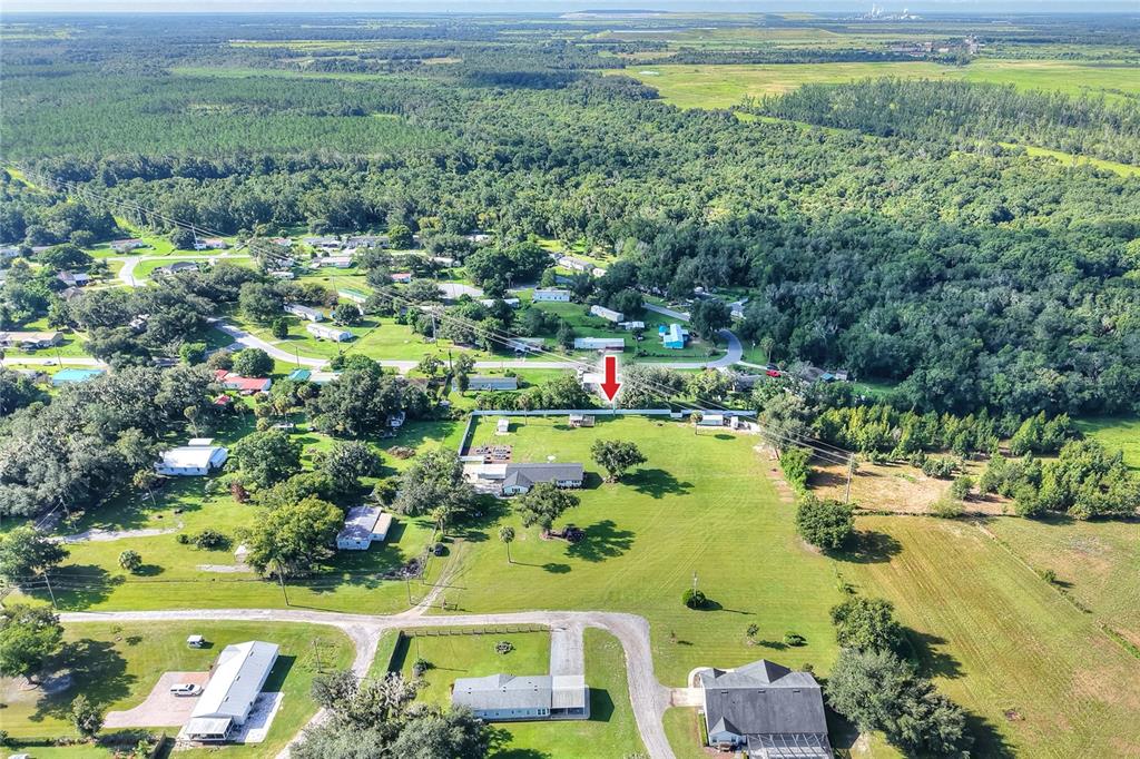 An aerial view shows a residential property with a house and large yard — 4220 HOWELL LANE, MULBERRY, FL