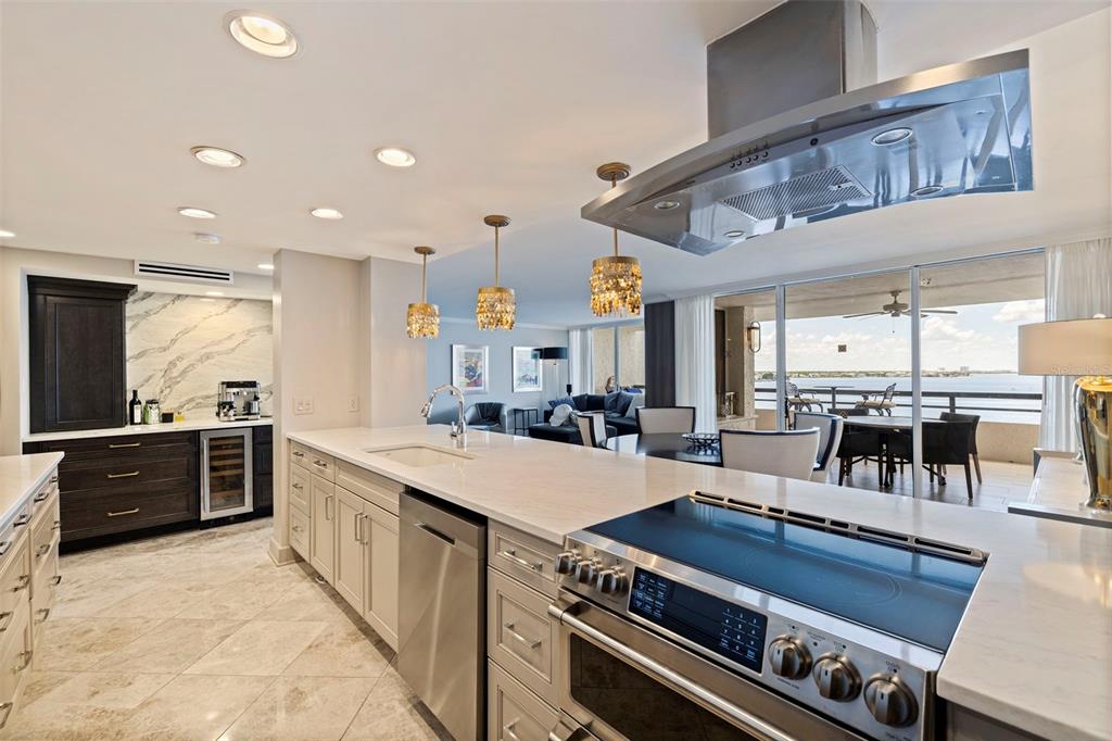 A modern kitchen with white countertops, stainless steel appliances, and a view of the ocean — 5700 MARINER STREET UNIT 803, TAMPA, FL