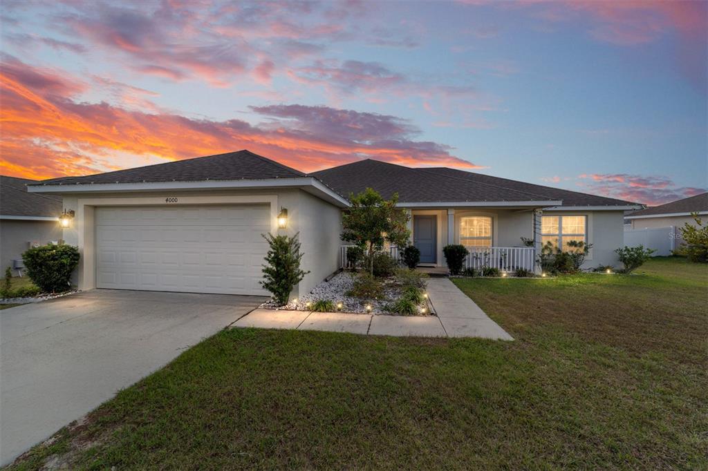 An entryway with tile flooring leads to a living area with wood floors and carpet — 4000 SE 98TH PLACE, BELLEVIEW, FL
