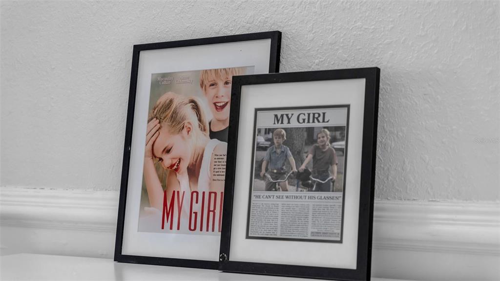 Two framed movie posters for My Girl sit on a white surface against a wall — 555 E STANFORD STREET, BARTOW, FL