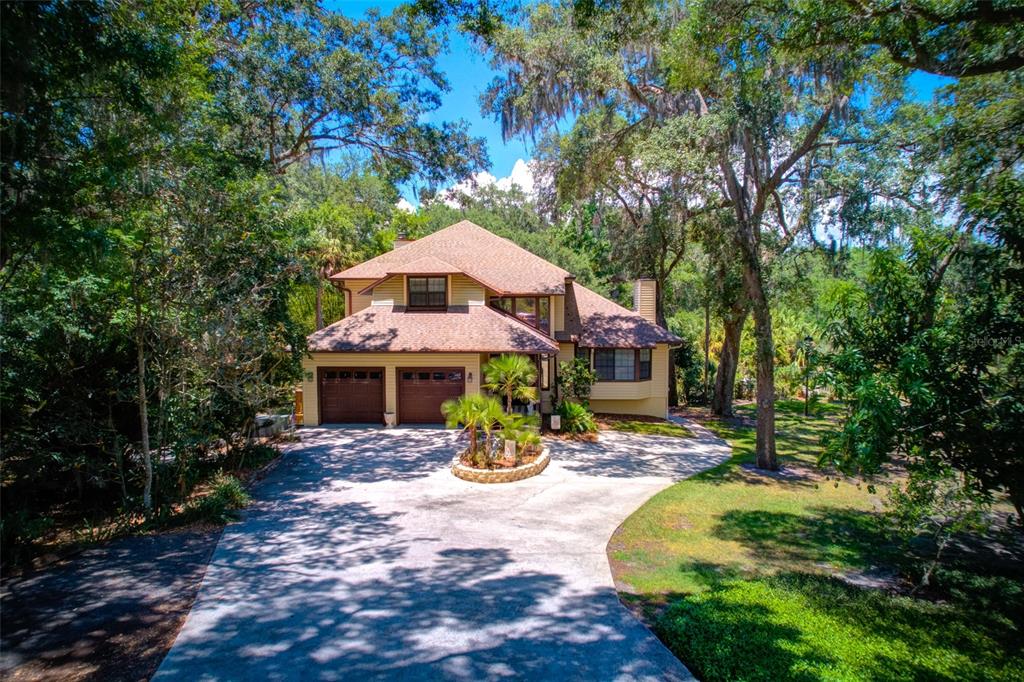 A two-story house with a brown roof and two-car garage sits at the end of a driveway — 11526 RIVER COUNTRY DRIVE, RIVERVIEW, FL