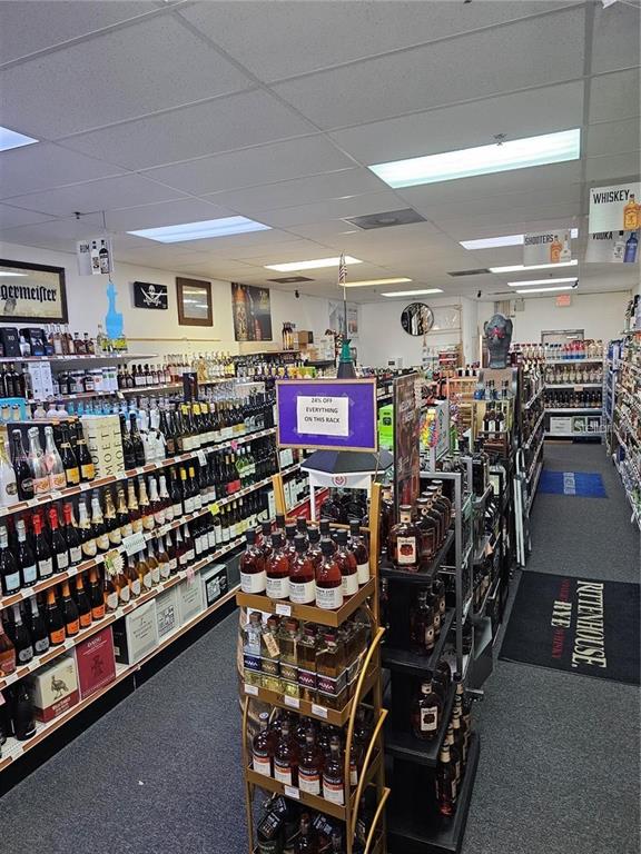 This liquor store interior features rows of shelves stocked with various bottles of alcohol — # CONFIDENTIAL, OVIEDO, FL
