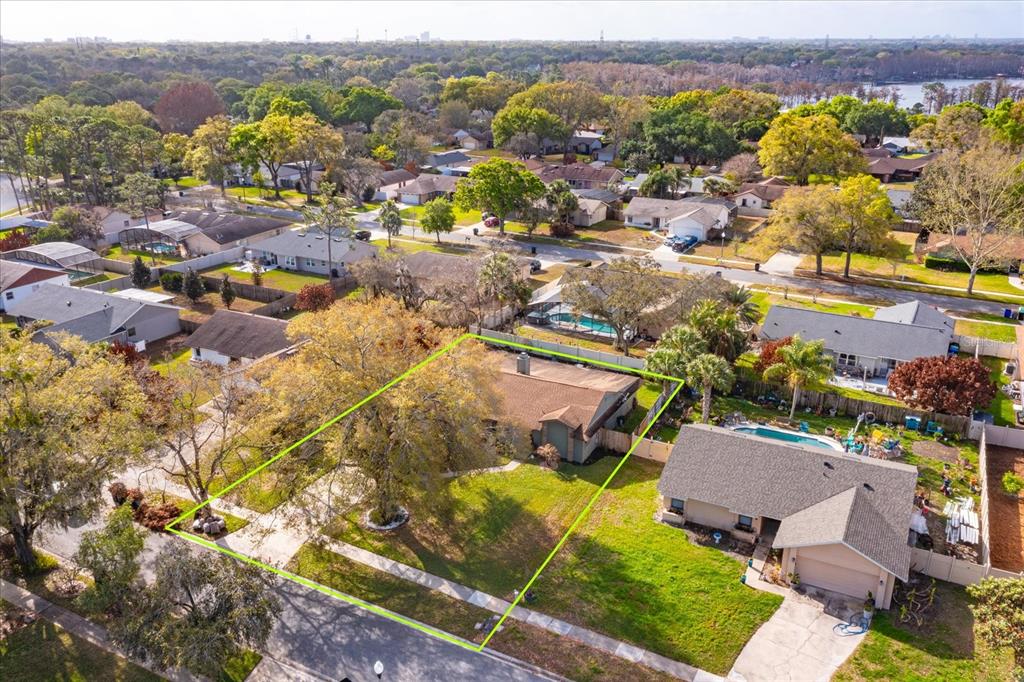 An aerial view shows a single-story house with a large front yard and mature trees — 9237 SABAL PALM CIRCLE, WINDERMERE, FL