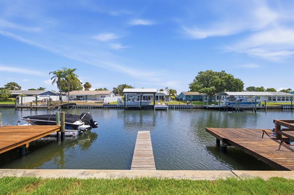 A teal-colored single-story building exterior features a white door, multiple windows, and a concrete walkway — 1041 APOLLO BEACH BOULEVARD UNIT E, APOLLO BEACH, FL