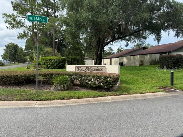A street sign for NE 16th Pl stands before a Fox Meadow neighborhood entrance sign — 1605 NE 38TH TERRACE, OCALA, FL
