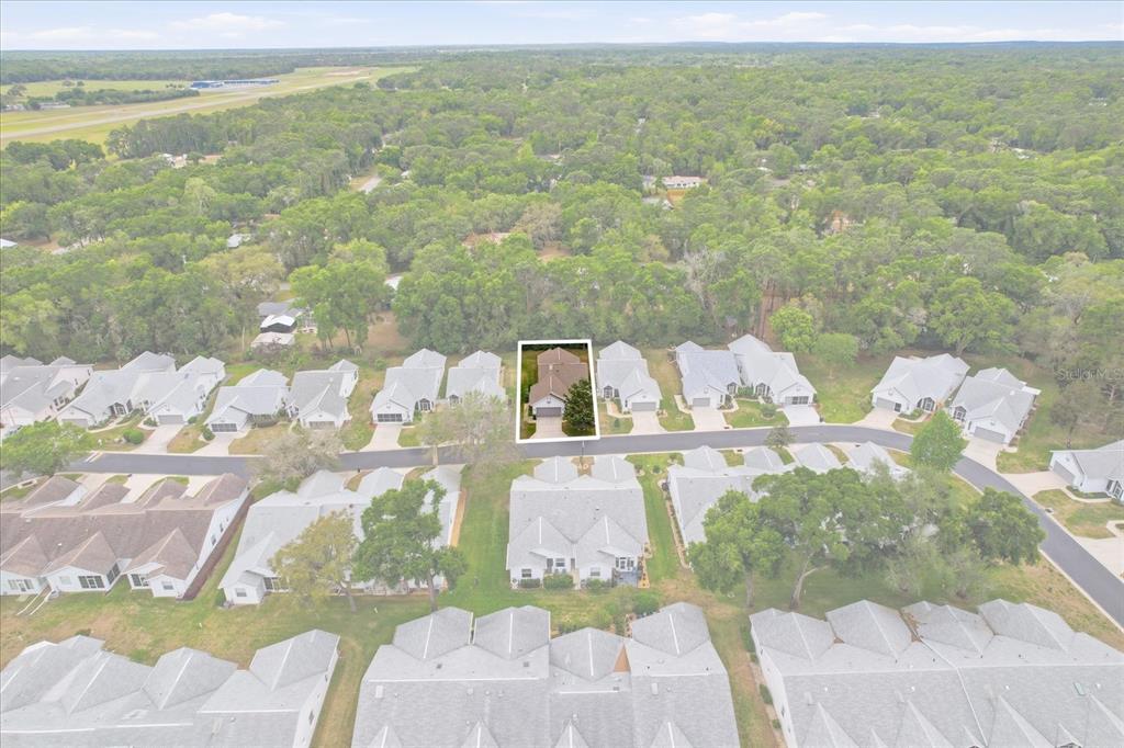 An aerial view shows a residential neighborhood with a single house highlighted by a box — 3569 S BELGRAVE DRIVE, INVERNESS, FL