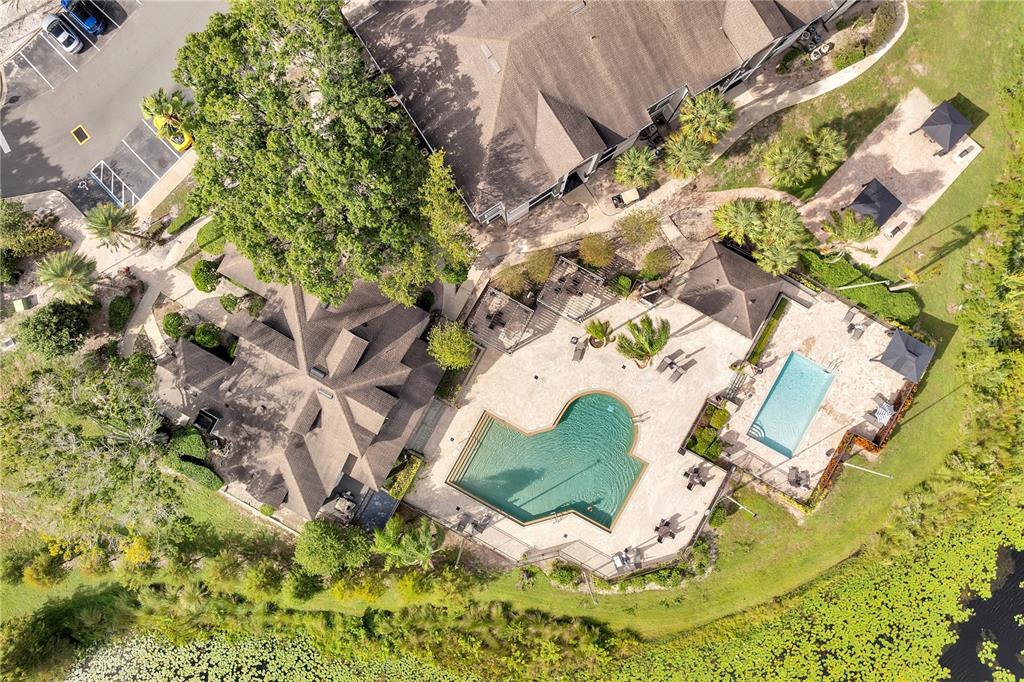 A three-story apartment building exterior features tan stucco walls, screened balconies, and a central staircase — 8825 LATREC AVENUE UNIT 6103, ORLANDO, FL