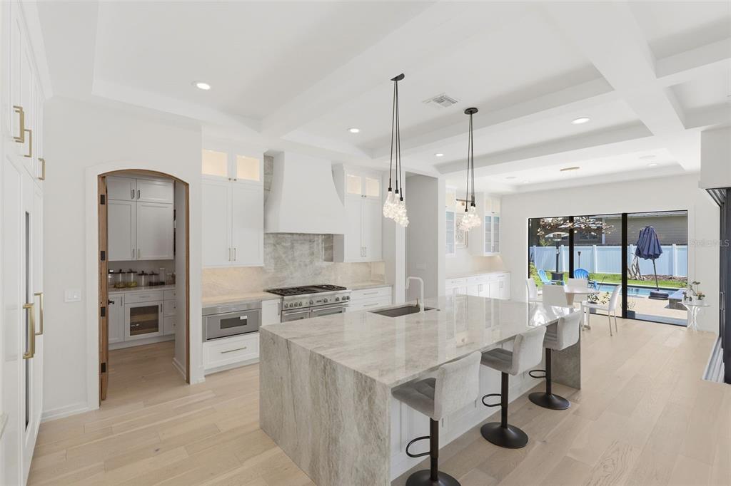 A bright entryway features light wood floors, a modern staircase, and a view toward the back — 809 E CHURCH STREET, ORLANDO, FL