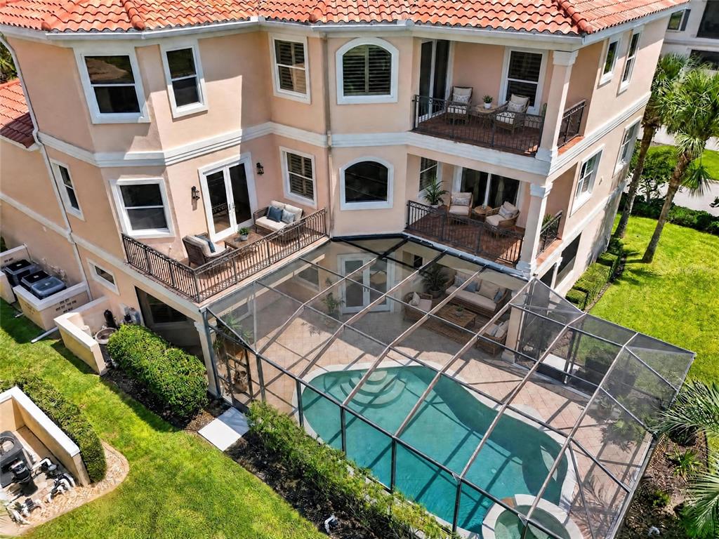 An aerial view of a multi-story house with balconies, a screened pool, and a patio — 1 OCEAN RIDGE BOULEVARD N, PALM COAST, FL