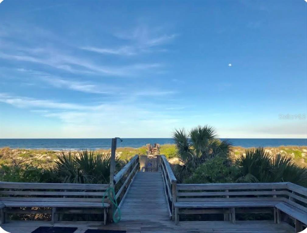 A wooden boardwalk leads through dunes to the ocean with benches on both sides — 6300 S A1A BOULEVARD UNIT A93U, ST AUGUSTINE, FL