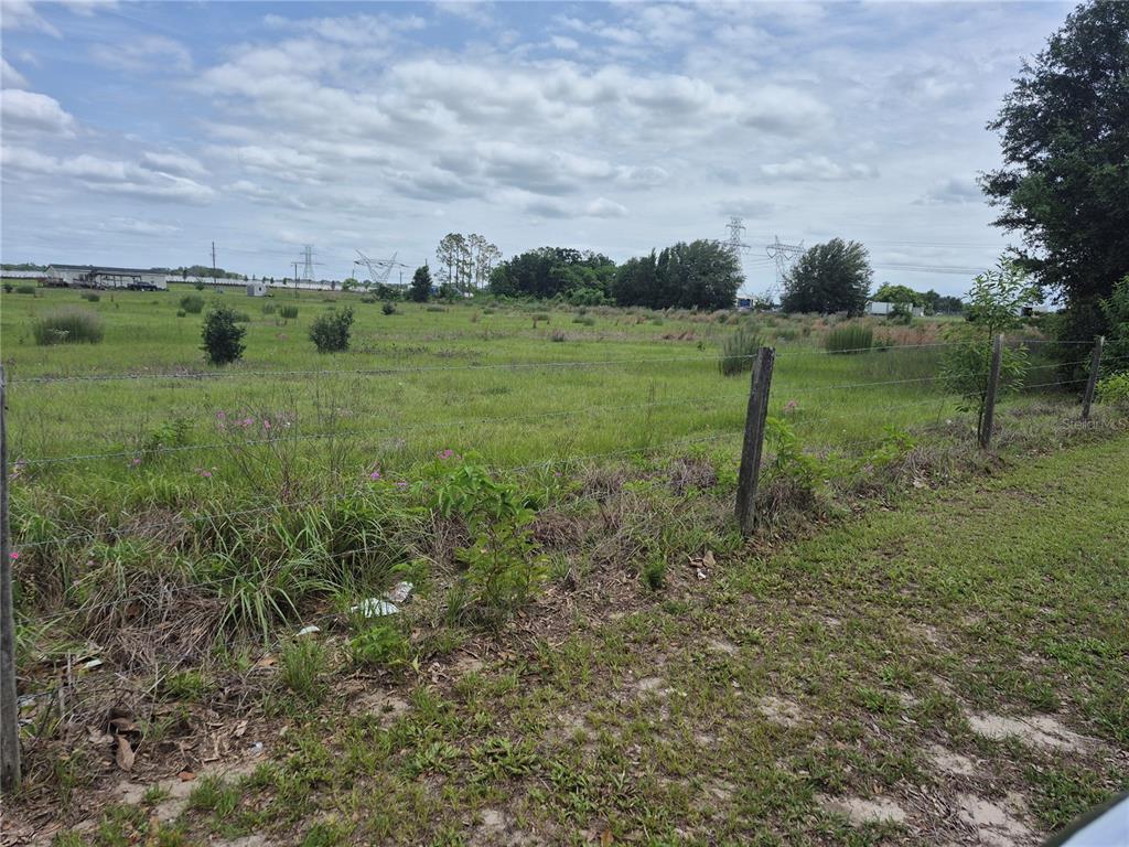 A view of a flat, grassy vacant lot enclosed by a wire fence — CR 229, WILDWOOD, FL