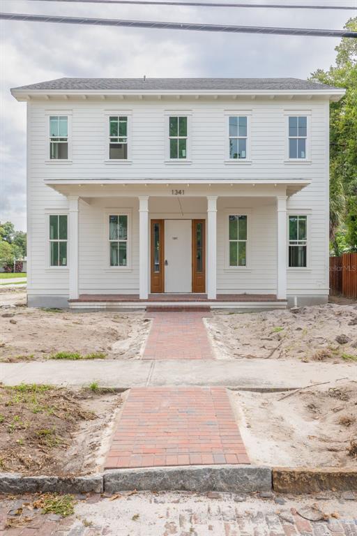 A two-story house under construction with orange ZIP System sheathing and a front porch — 1341 28TH AVENUE N, ST PETERSBURG, FL