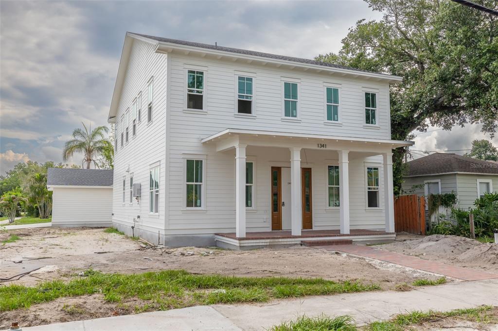 A two-story house under construction with exposed ZIP System sheathing and a front porch — 1341 28TH AVENUE N, ST PETERSBURG, FL