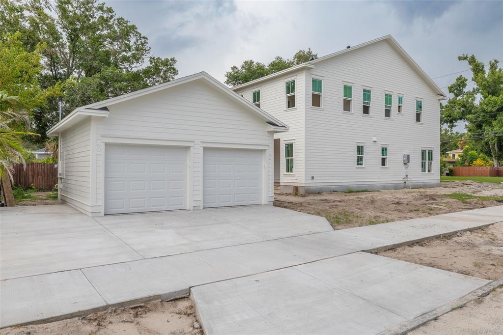 A two-story house under construction features ZIP System sheathing, installed windows, and a front porch — 1341 28TH AVENUE N, ST PETERSBURG, FL