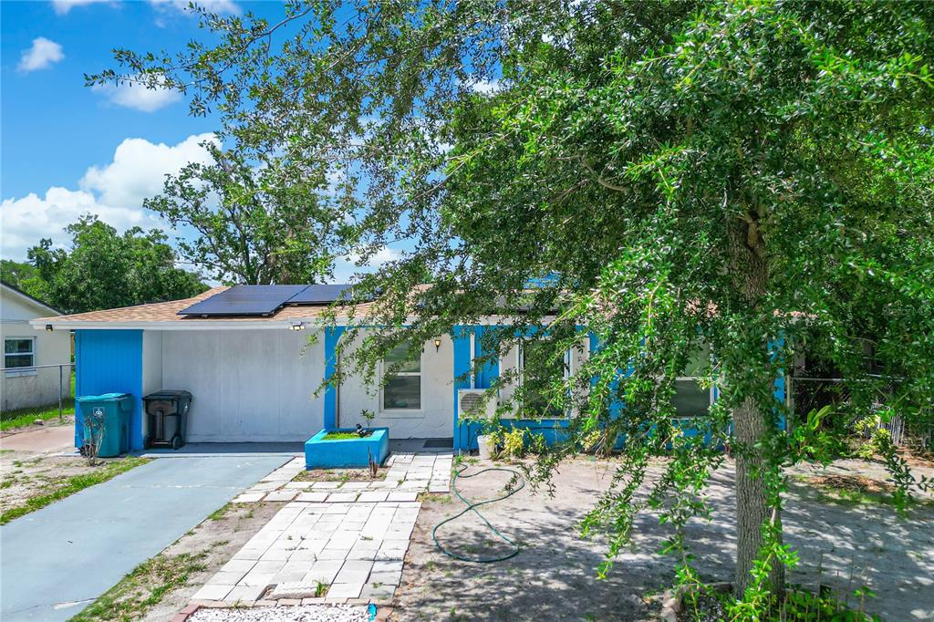 A blue single-story house with a driveway and a for sale sign in the yard — 4671 VERGARA COURT, ORLANDO, FL