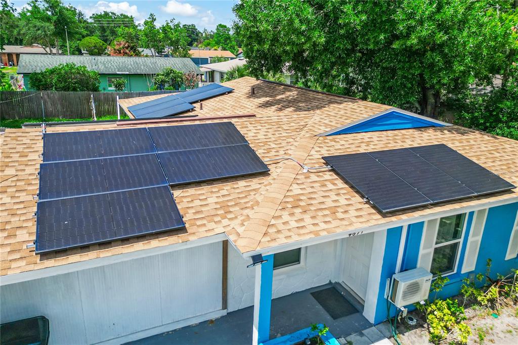 A bright blue exterior house features a white front door and a raised garden bed — 4671 VERGARA COURT, ORLANDO, FL