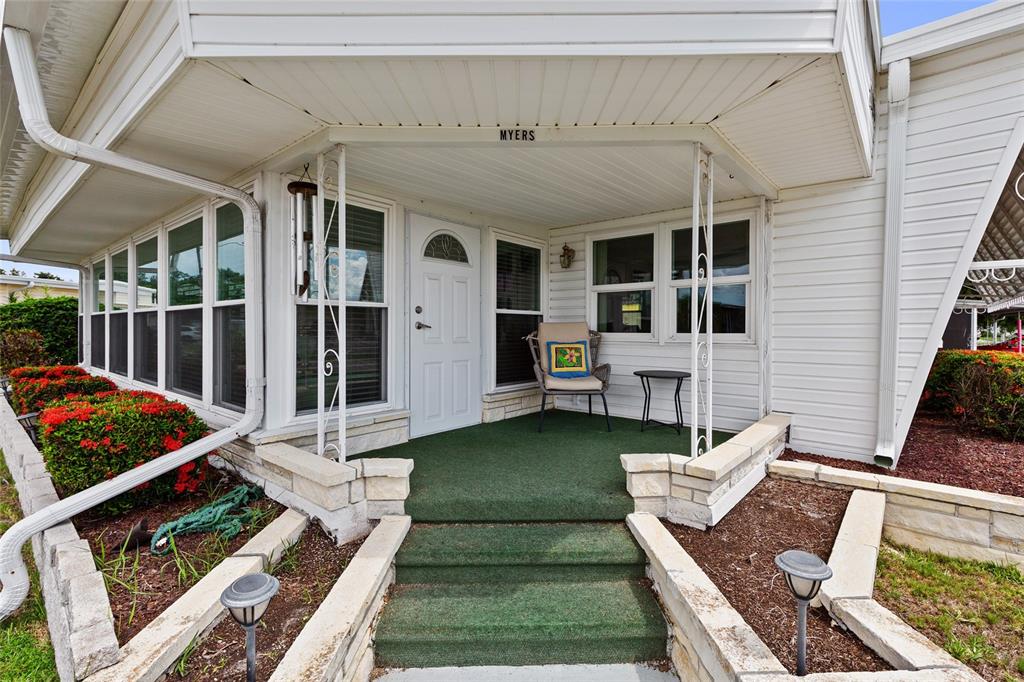 A kitchen features white cabinets, a white stove, a dishwasher, and light blue walls — 1111 42ND AVENUE E, ELLENTON, FL