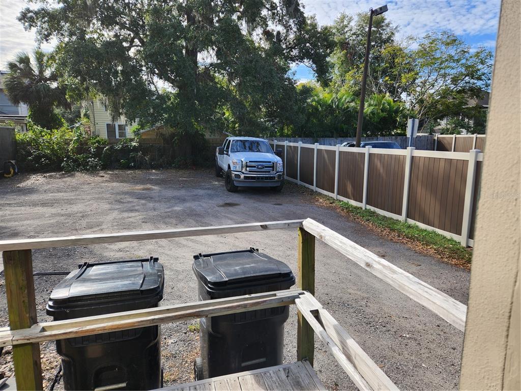 A gravel parking area with two trash cans and a white pickup truck — 1412 E ROBINSON STREET, ORLANDO, FL
