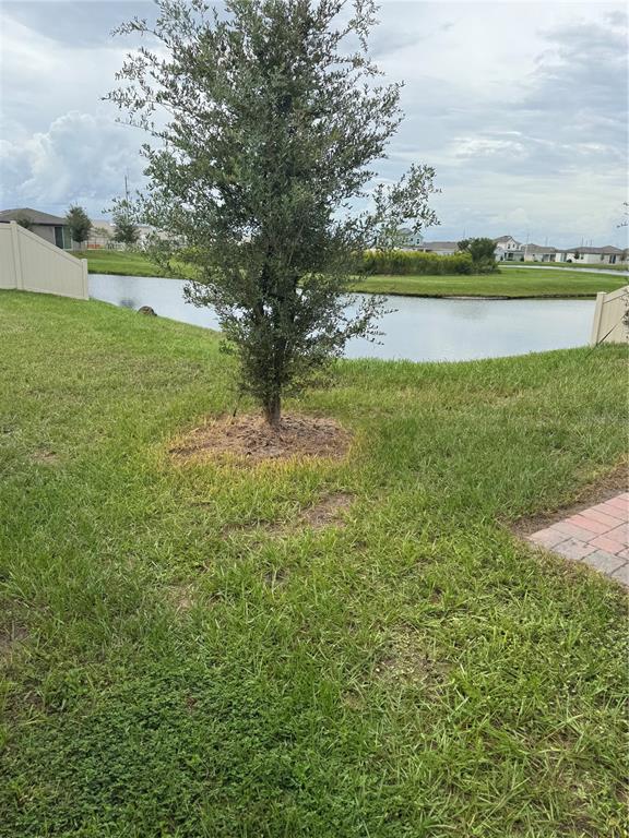 A single-story house features a tan exterior, a two-car garage, and a brick paver driveway — 3181 VICEROY COURT, KISSIMMEE, FL