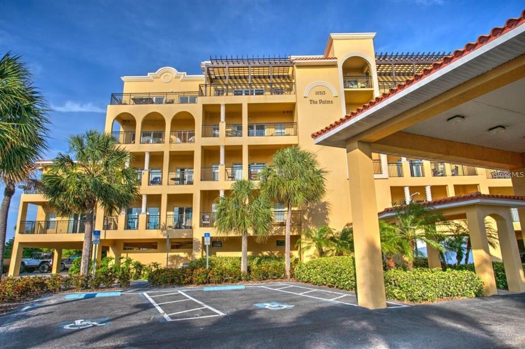 A balcony with a metal railing, a lounge chair, and a view of the water — 10315 GULF BOULEVARD UNIT 409, TREASURE ISLAND, FL