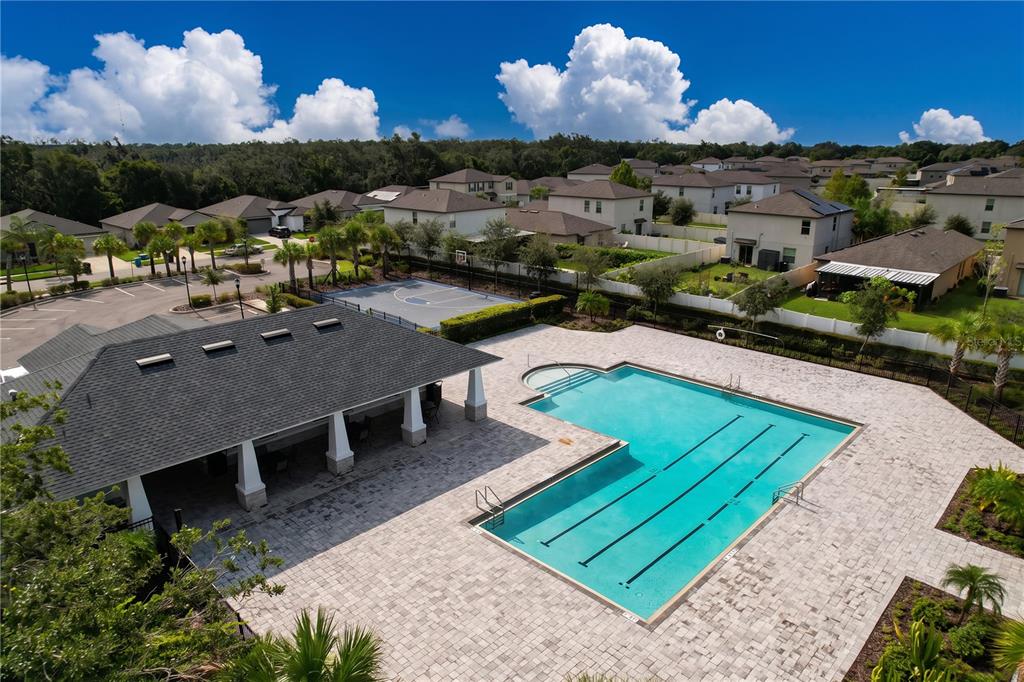 An aerial view shows a community swimming pool, a covered pavilion, and a basketball court — 1565 COLDING DRIVE, RUSKIN, FL