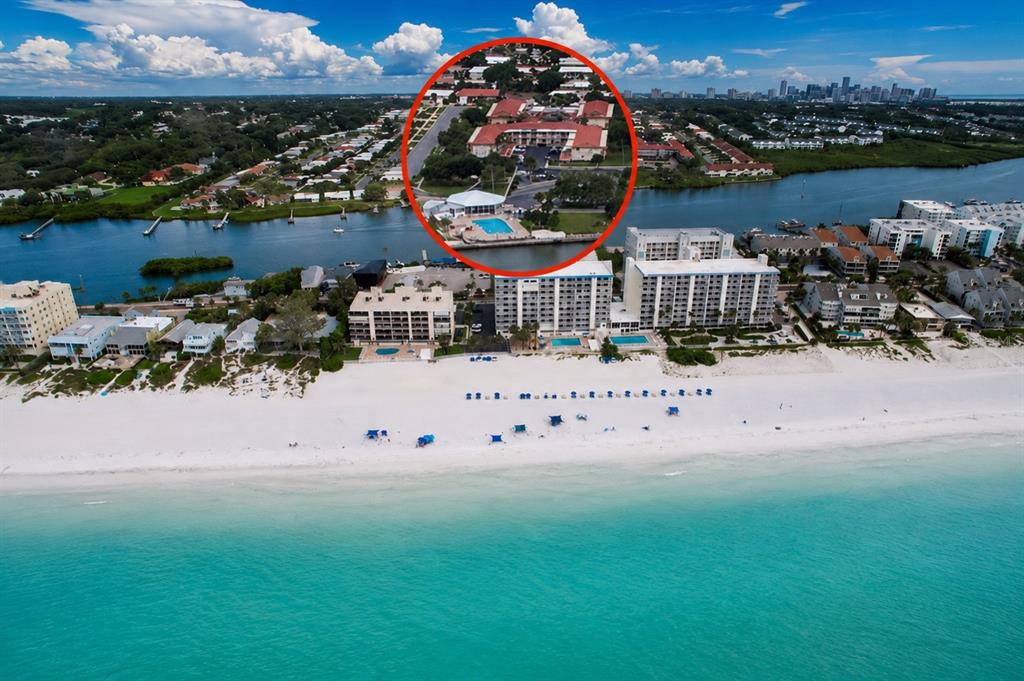 An aerial view shows beachfront condominiums with a circular inset highlighting a nearby residential complex — 10351 REGAL DRIVE UNIT 5, LARGO, FL