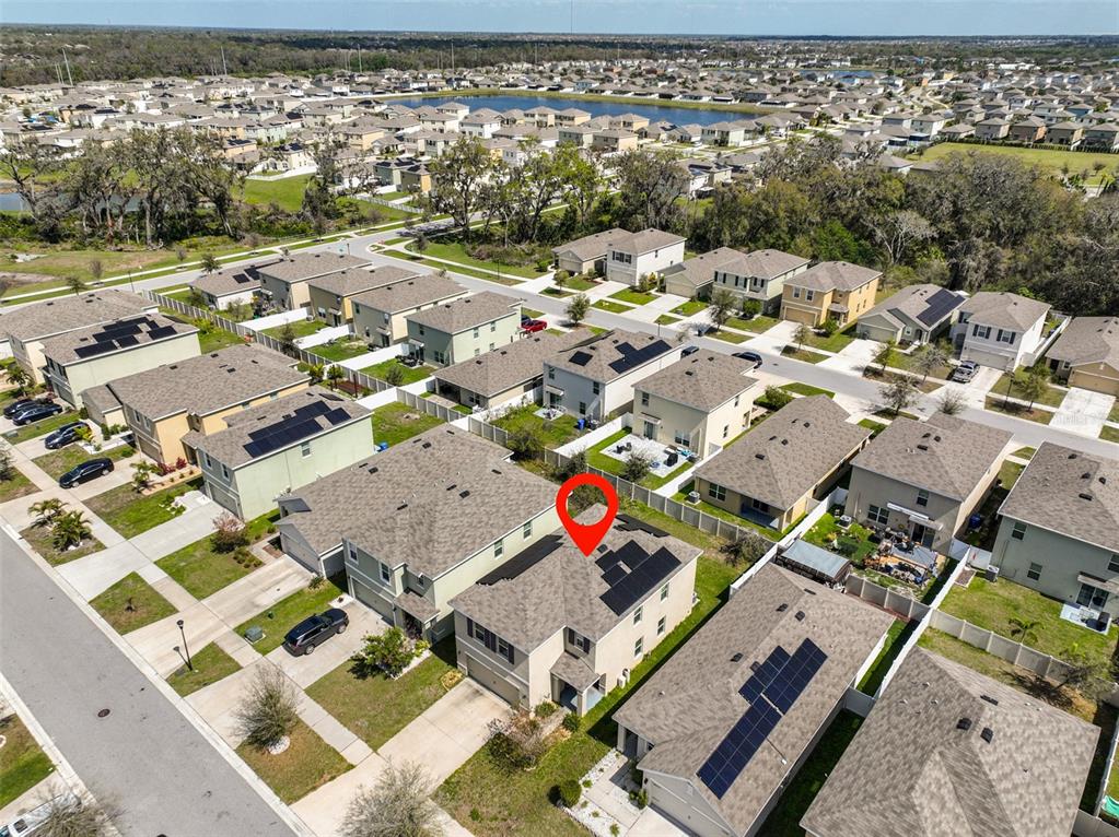 An aerial view shows a suburban neighborhood with a red marker on a two-story house — 10967 CARLTON FIELDS DRIVE, RIVERVIEW, FL