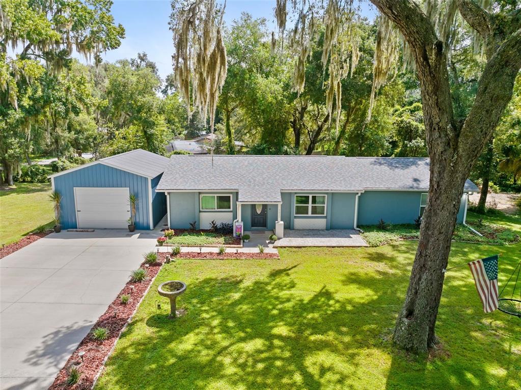 An aerial view of a blue single-story house with a garage and a large yard — 7625 S ANNIE TERRACE, FLORAL CITY, FL