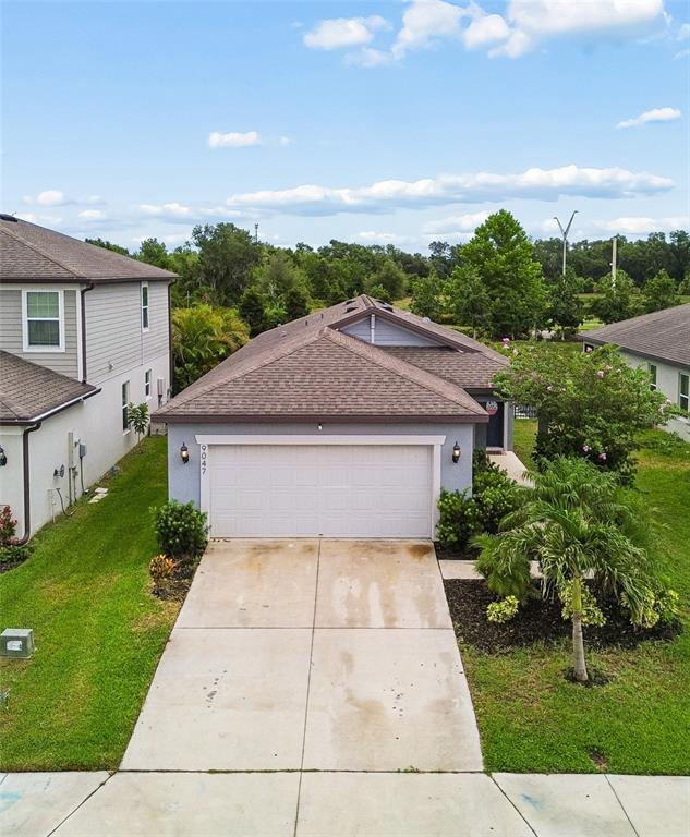 An aerial view of a single-story house with a two-car garage and concrete driveway — 9047 ROYAL RIVER CIRCLE, PARRISH, FL