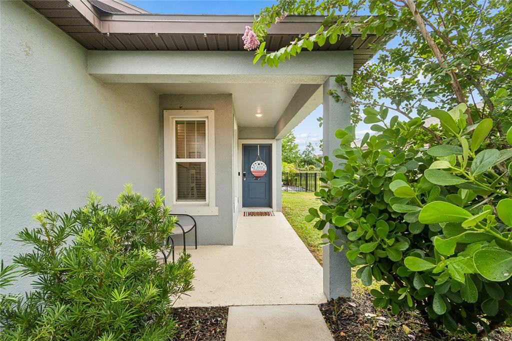 A hallway features blue wainscoting, white hexagonal wallpaper, tile flooring, and a marble-topped console table — 9047 ROYAL RIVER CIRCLE, PARRISH, FL